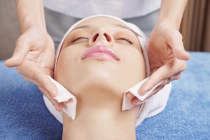 Beautician applying toner