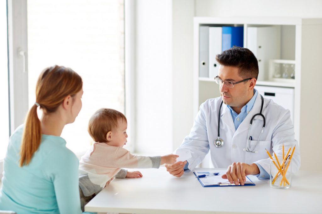 woman with baby and doctor at clinic